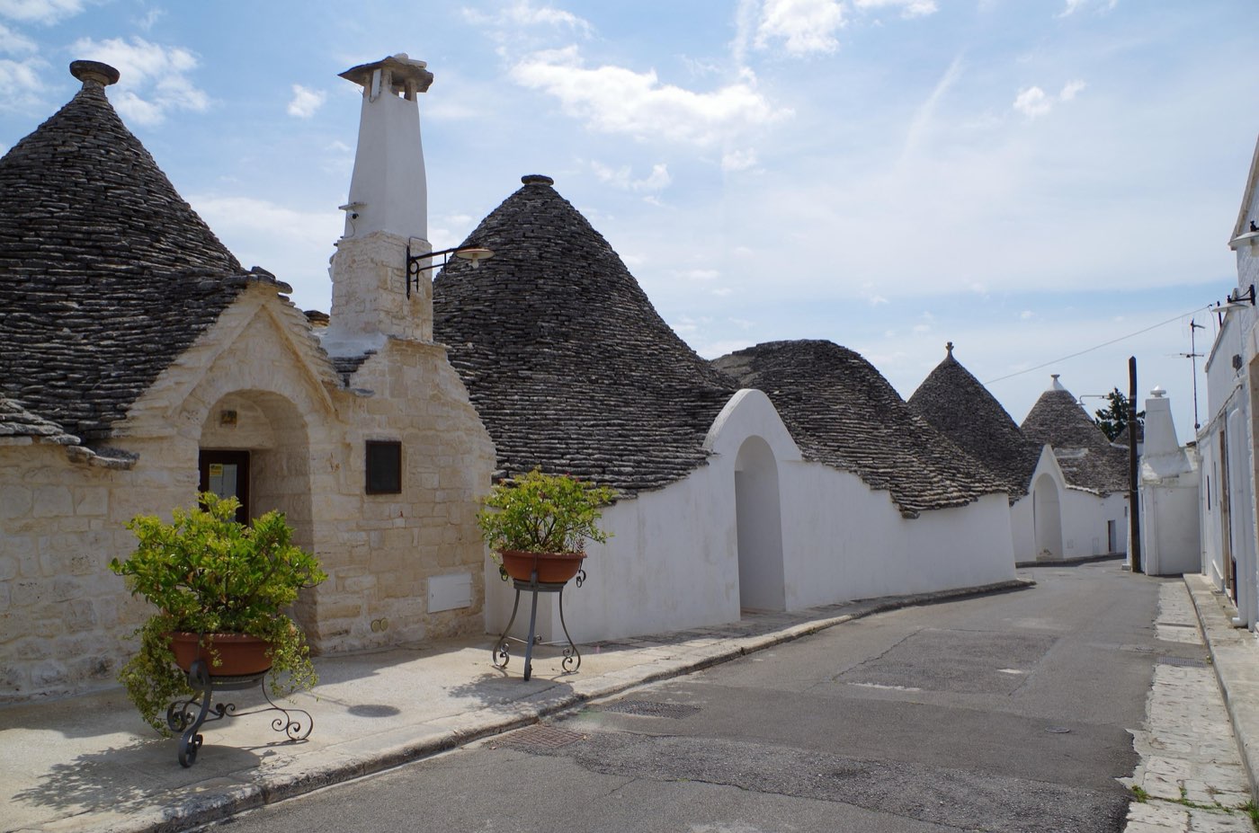 Conical trulli roofs among the vineyards of the Itria Valley